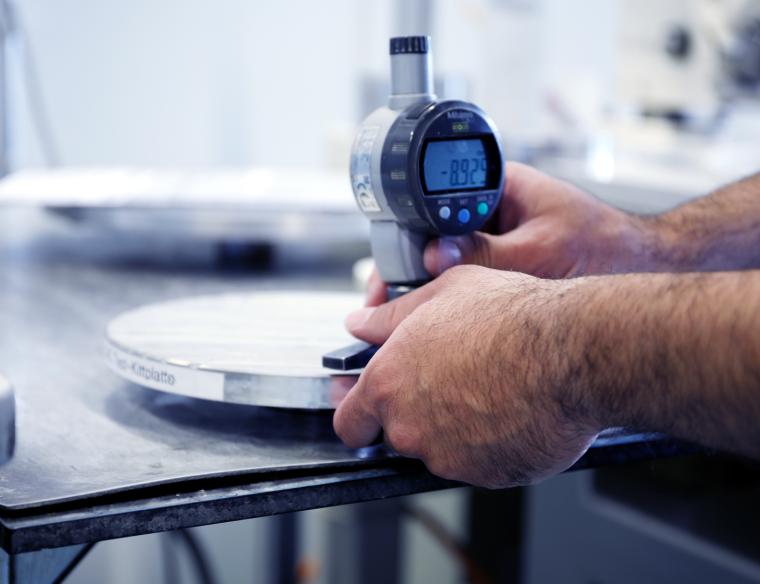 Unsere Mitarbeiter geben alles für Ihr Produkt. Ein FISBA Mitarbeiter kontrolliert den Messwert der Linsen.